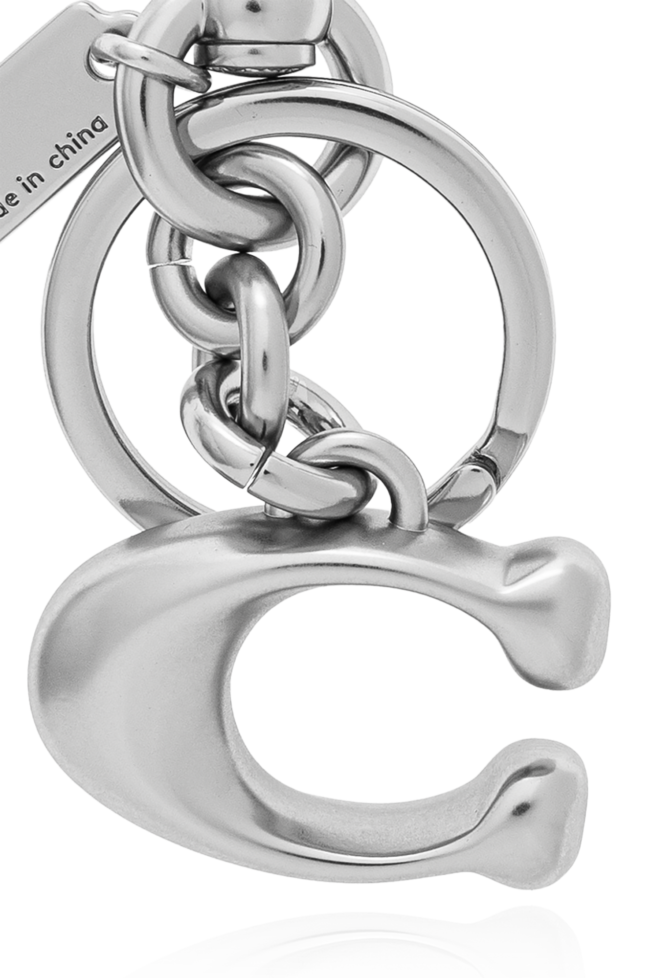 Silver Keychain with a pendant in the shape of a logo Coach